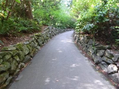 Paved trail with rock retaining wall along the edges
